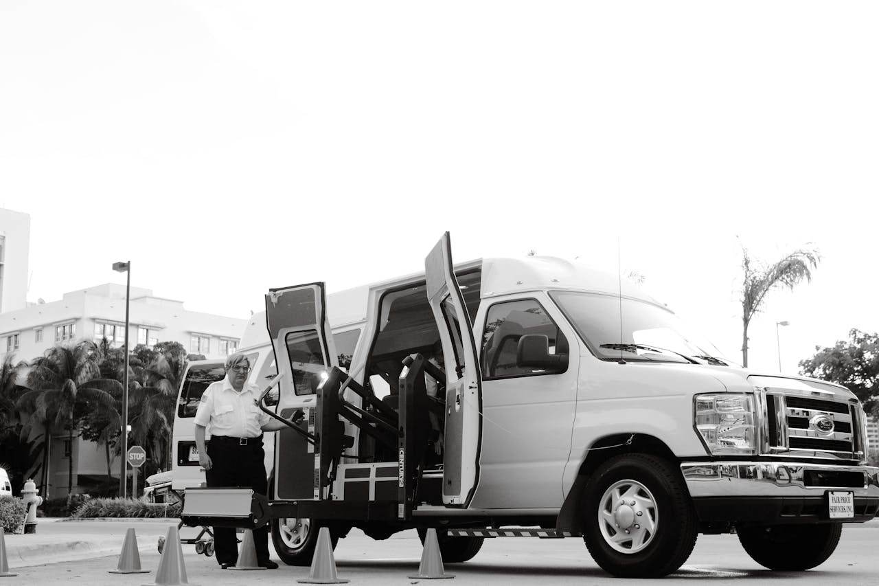 portfolio-05 A black and white image depicting an accessible transport van with a lift, enhancing mobility for passengers with disabilities.