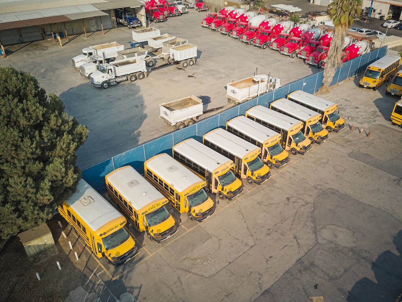 portfolio-06 Aerial view of school buses and trucks parked in an industrial lot.